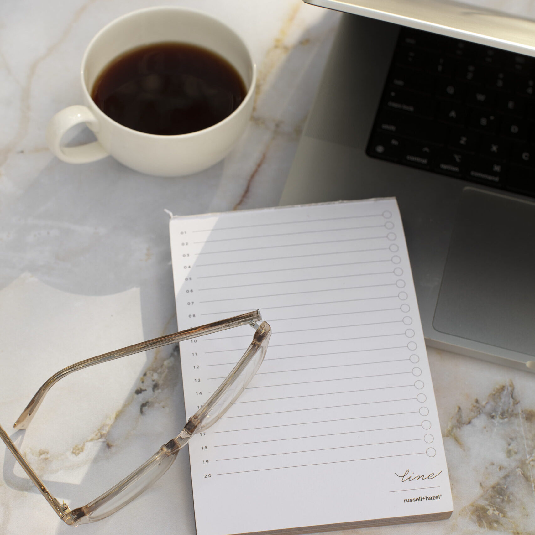 Picture of a notebook, laptop and cup of coffee